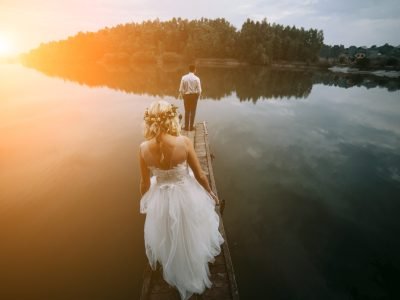 Wedding couple on the old wooden pier posing for the camera